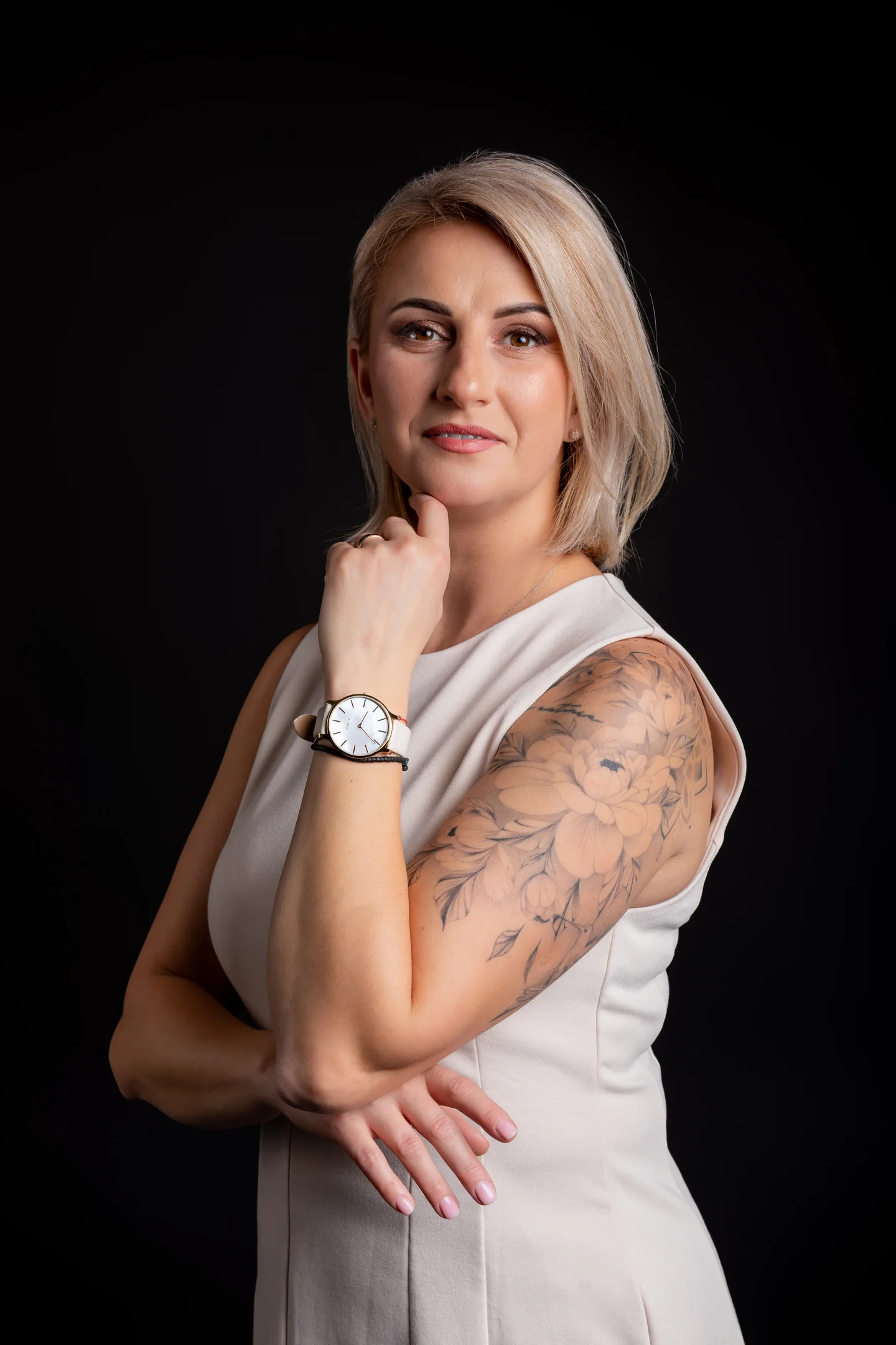 Portret în top alb, cu brațul tatuat vizibil, pe fundal negru — fotografie business în Oradea