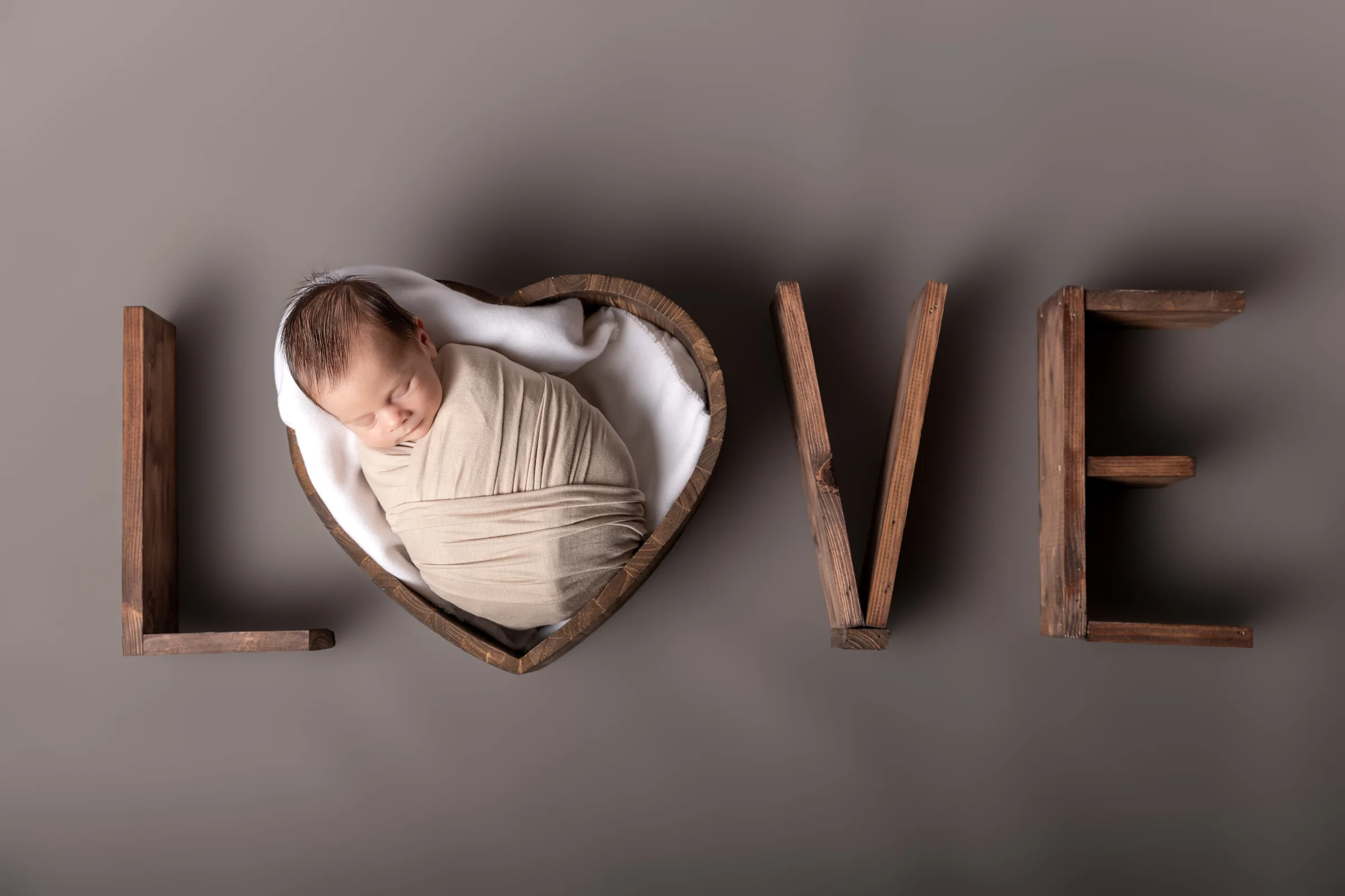 Nou-născut înfășurat, așezat într-o inimă lângă literele LOVE — ședință foto newborn în Oradea